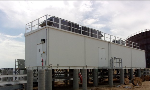 JQMC MCC power distribution building elevated on concrete piers with rooftop equipment platform