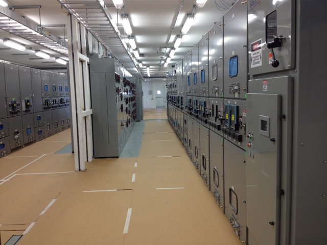 JQMC switchgear building interior — full cabinet lineup on the factory floor before delivery